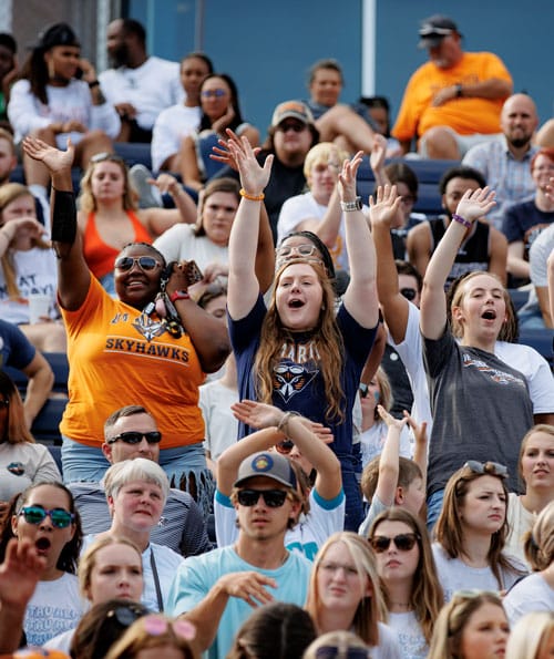 Young women cheering with hands raised