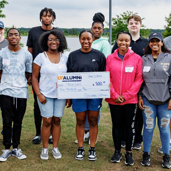 Shelby County Skyhawks with scholarship check
