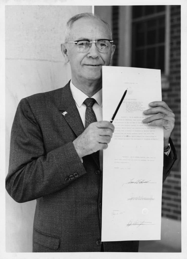 Pictured is Dr. Paul Meek with a copy of the bill and the pen that Governor Ellington used to sign it.