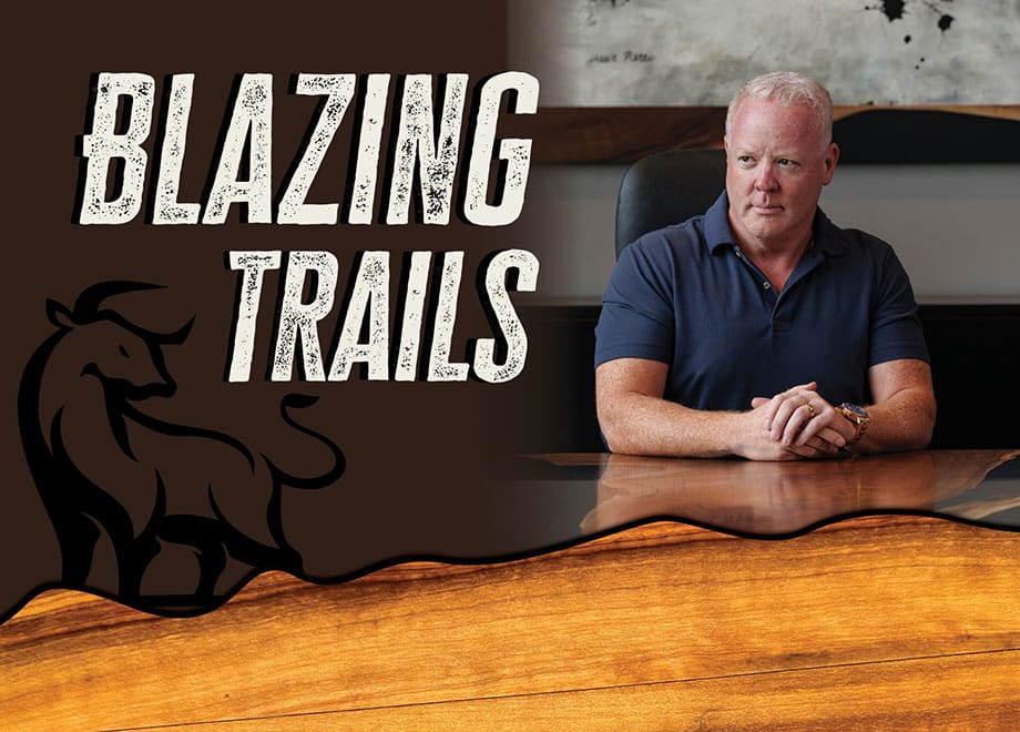 Mark Joyner sits at a table. An illustration of a bull and the words Blazing Trails appear over the photo.